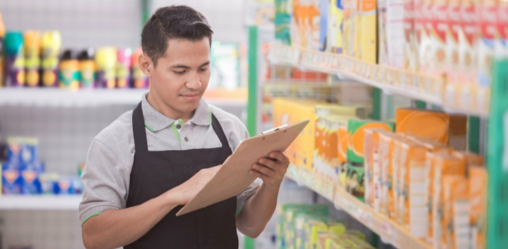 AI-powered CPG distribution analytics, with a field manager reviewing retail shelf data using real-time digital insights.